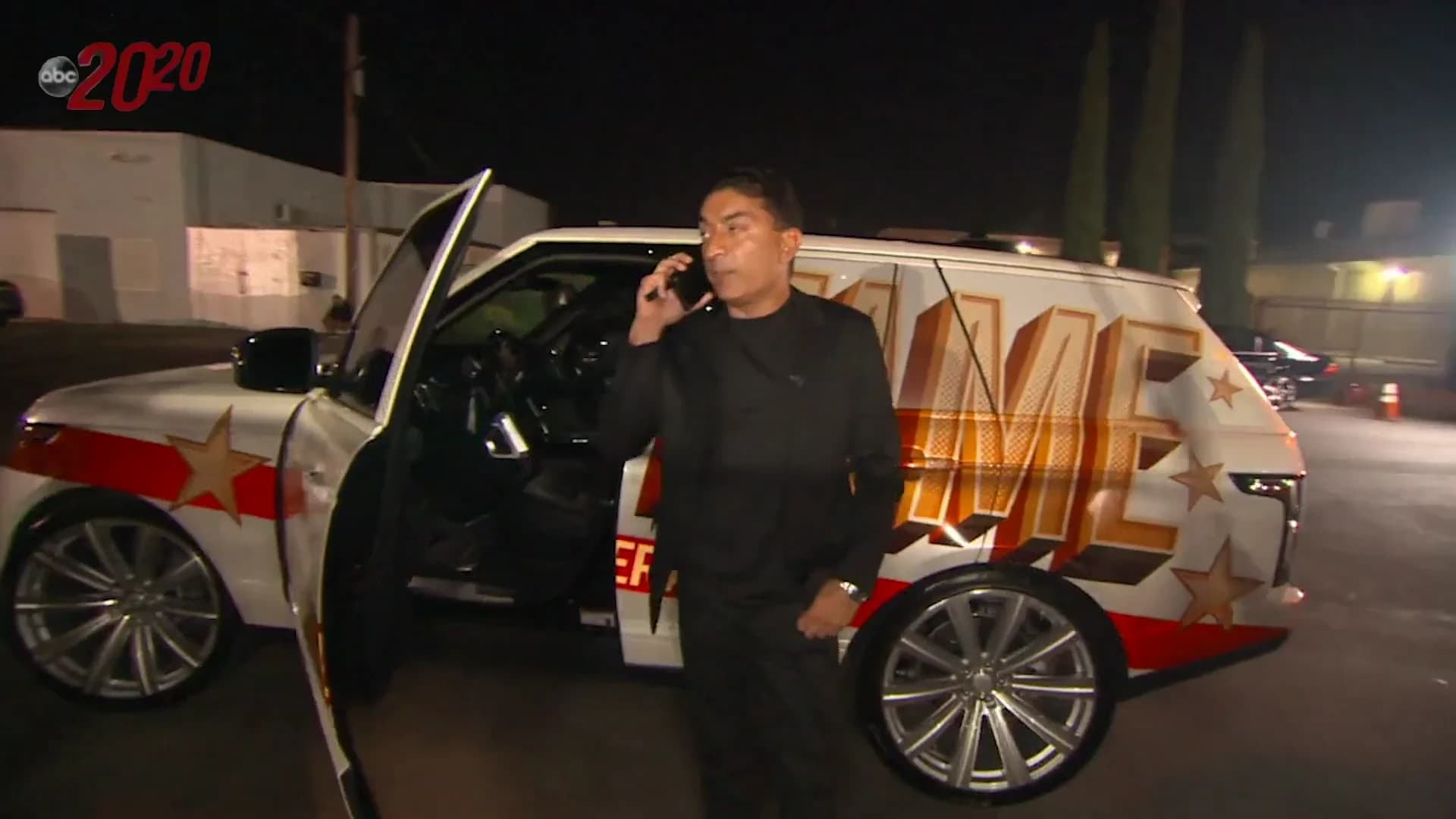 Sheeraz Hasan coordinating by phone beside a Fame by Sheeraz vehicle in the ABC 20/20 broadcast