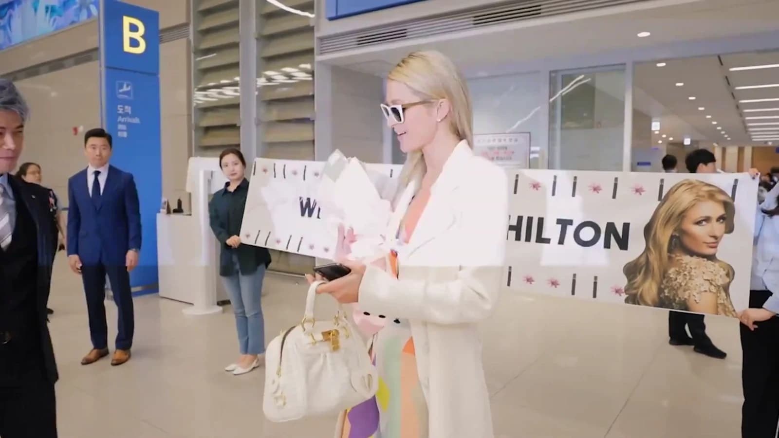 Paris Hilton arriving in Seoul beside a branded airport welcome